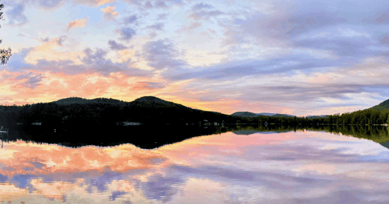 Sunset on Lake with dark mountains in the background